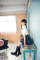 A young girl sitting on a bench in a room.